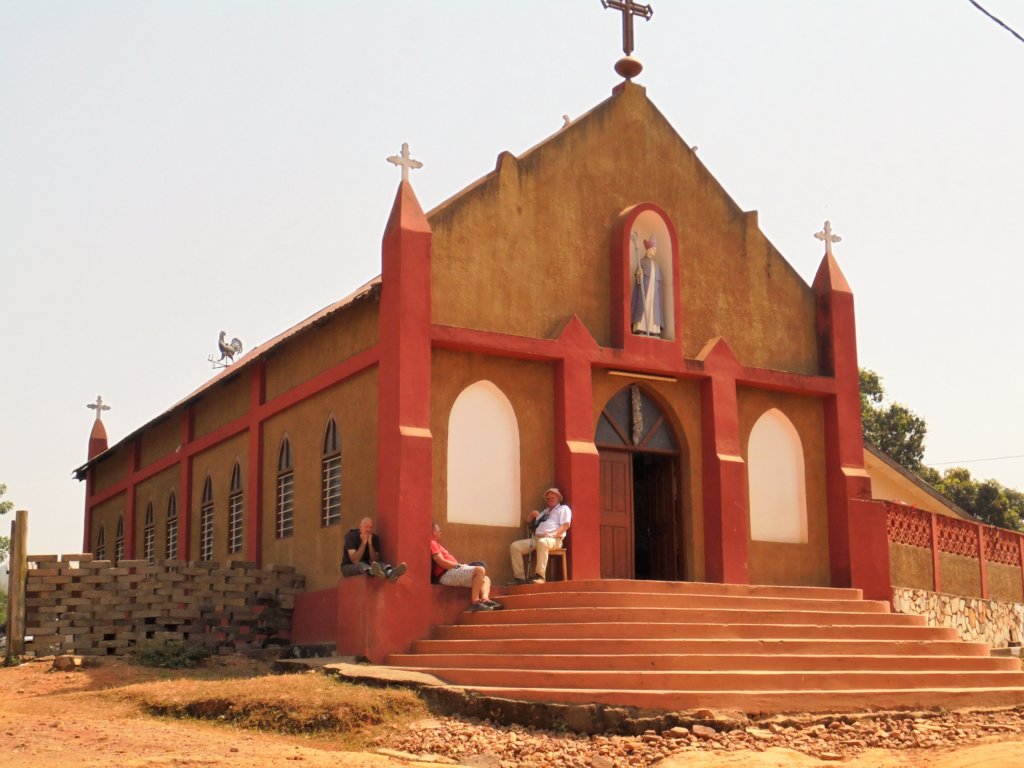 This picture shows three guys from our group resting in the shade on the steps of a church