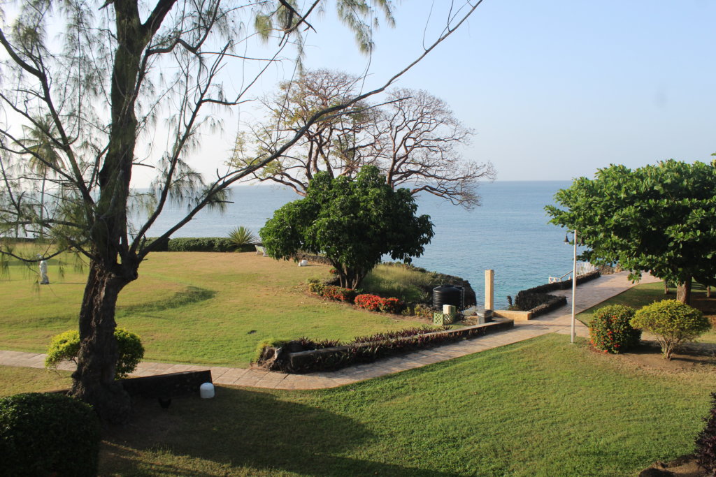 This photo shows the view from our balcony with the lush green lawn with the blue ocean behind.