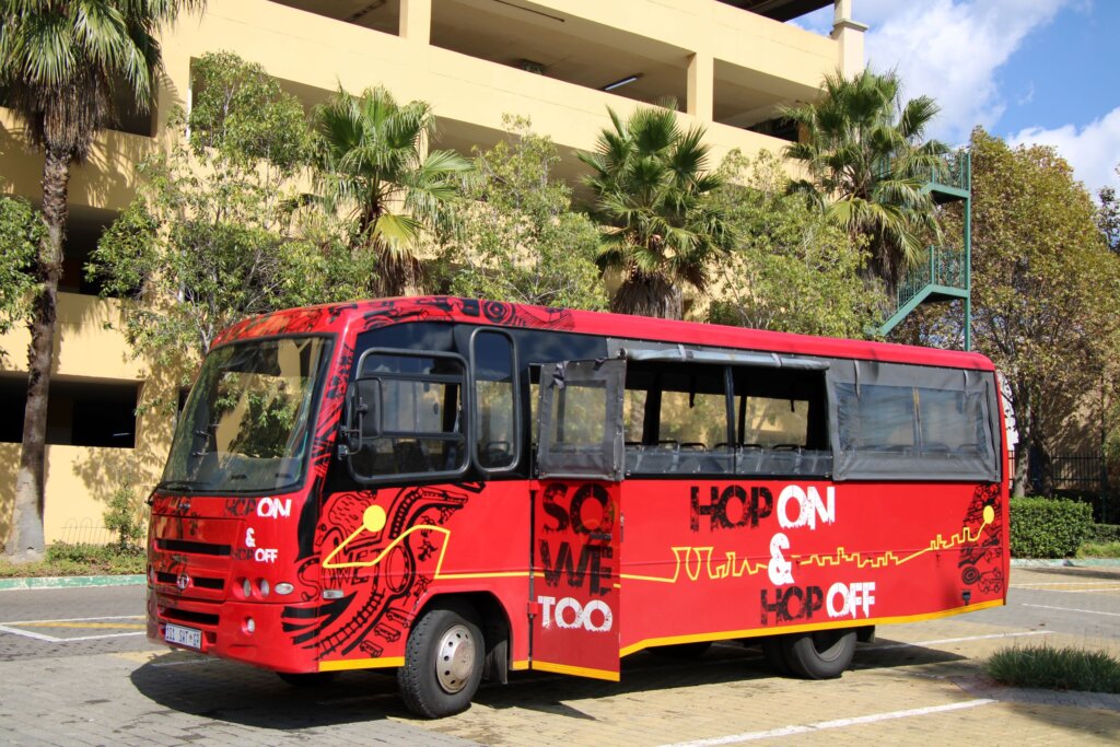 This image shows a bright red minibus waiting to take us on our tour of Soweto